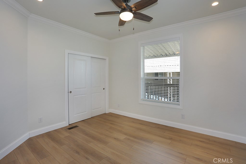 129 La Ronda Tustin, CA 92780 - Photo 12 of 33 a view of an empty room with a window and wooden floor