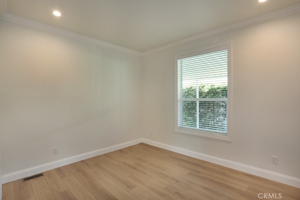 129 La Ronda Tustin, CA 92780 - Photo 14 of 33 an empty room with wooden floor and windows