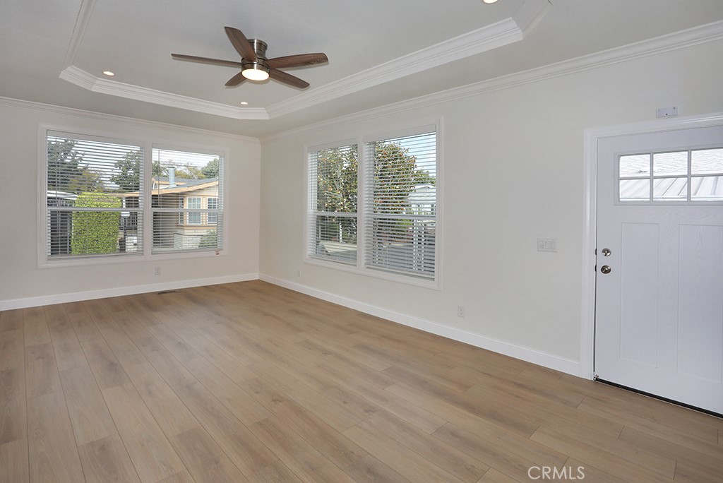 129 La Ronda Tustin, CA 92780 - Photo 18 of 33 a view of an empty room with a window and wooden floor