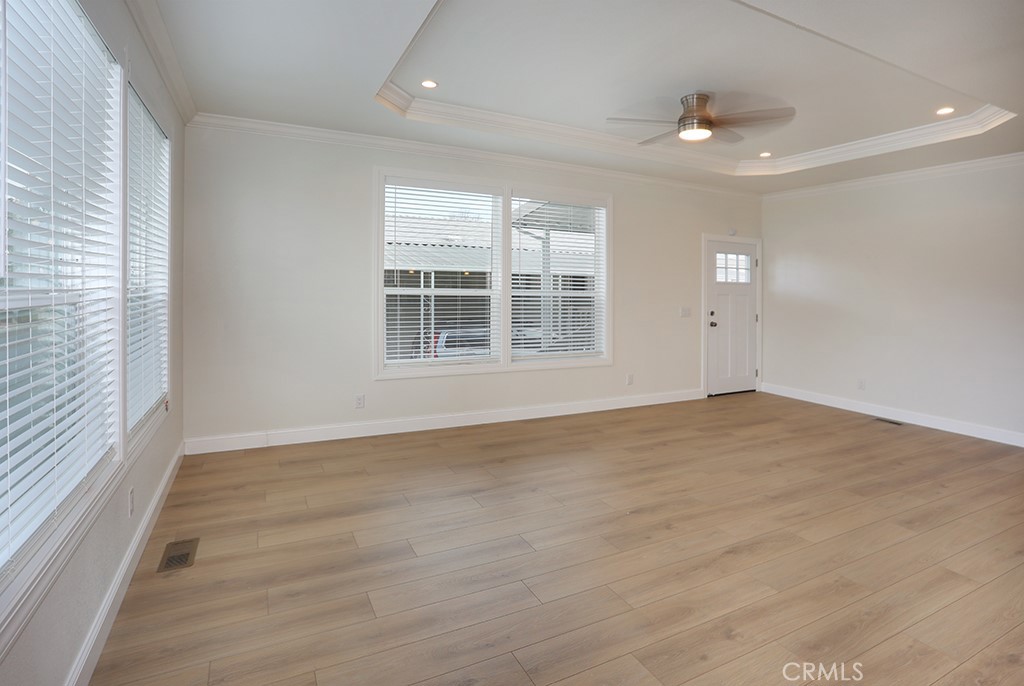129 La Ronda Tustin, CA 92780 - Photo 19 of 33 an empty room with wooden floor and windows