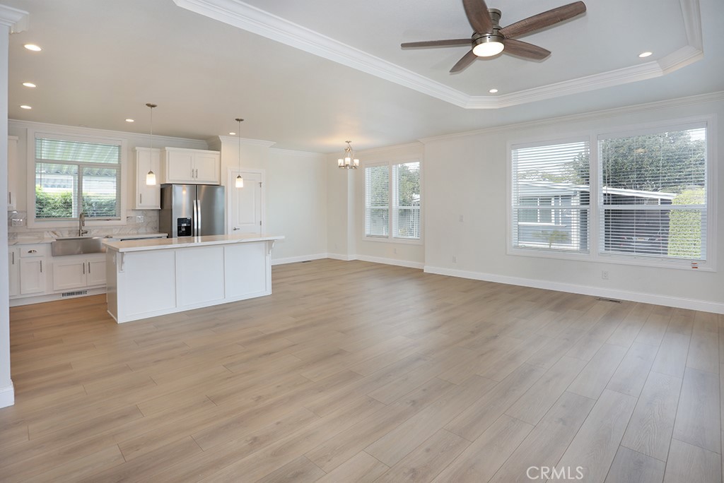 129 La Ronda Tustin, CA 92780 - Photo 20 of 33 an empty room with wooden floor and windows