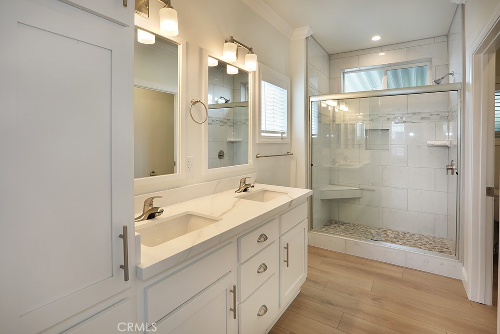 129 La Ronda Tustin, CA 92780 - Photo 21 of 33 a bathroom with a double vanity sink mirror double shower and a bathtub
