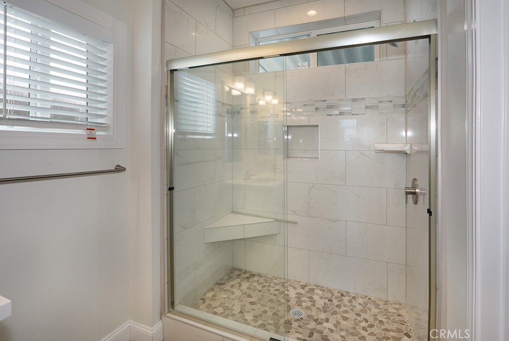 129 La Ronda Tustin, CA 92780 - Photo 22 of 33 a bathroom with a glass shower door