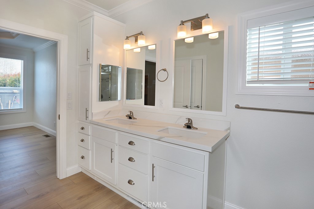 129 La Ronda Tustin, CA 92780 - Photo 23 of 33 a bathroom with double vanity sink a mirror and a shower