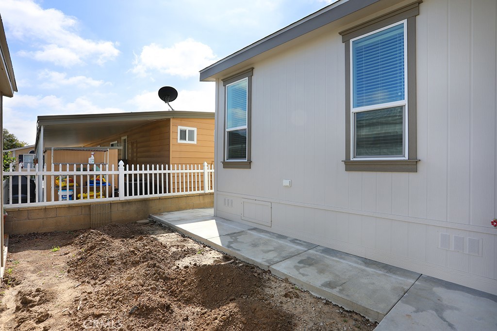 129 La Ronda Tustin, CA 92780 - Photo 33 of 33 a view of a house with a yard and wooden fence