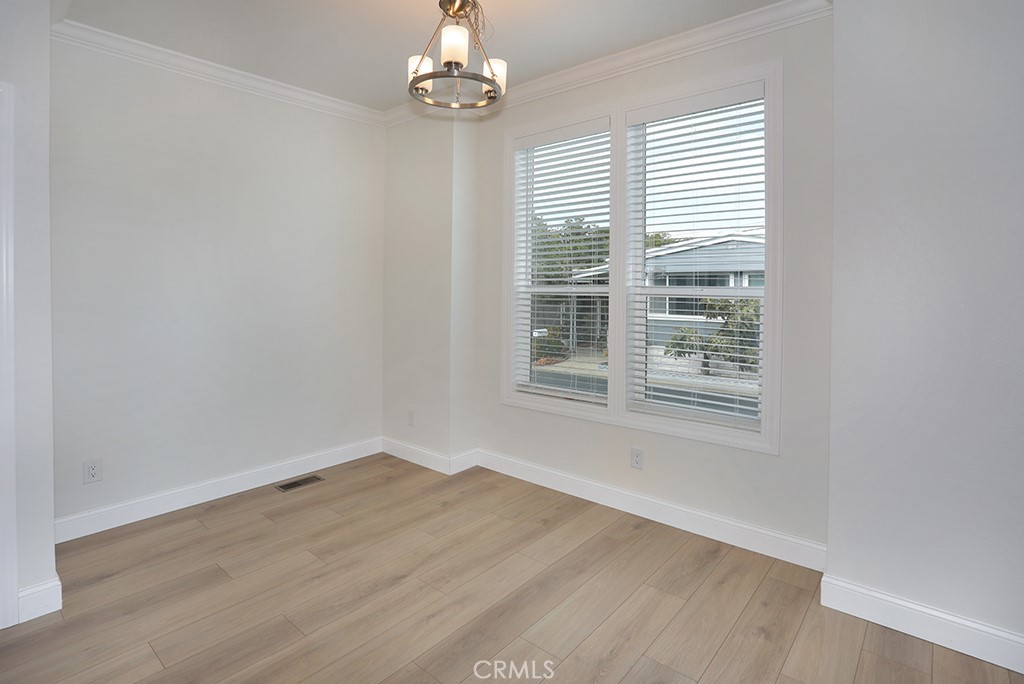 129 La Ronda Tustin, CA 92780 - Photo 10 of 33 an empty room with wooden floor and windows