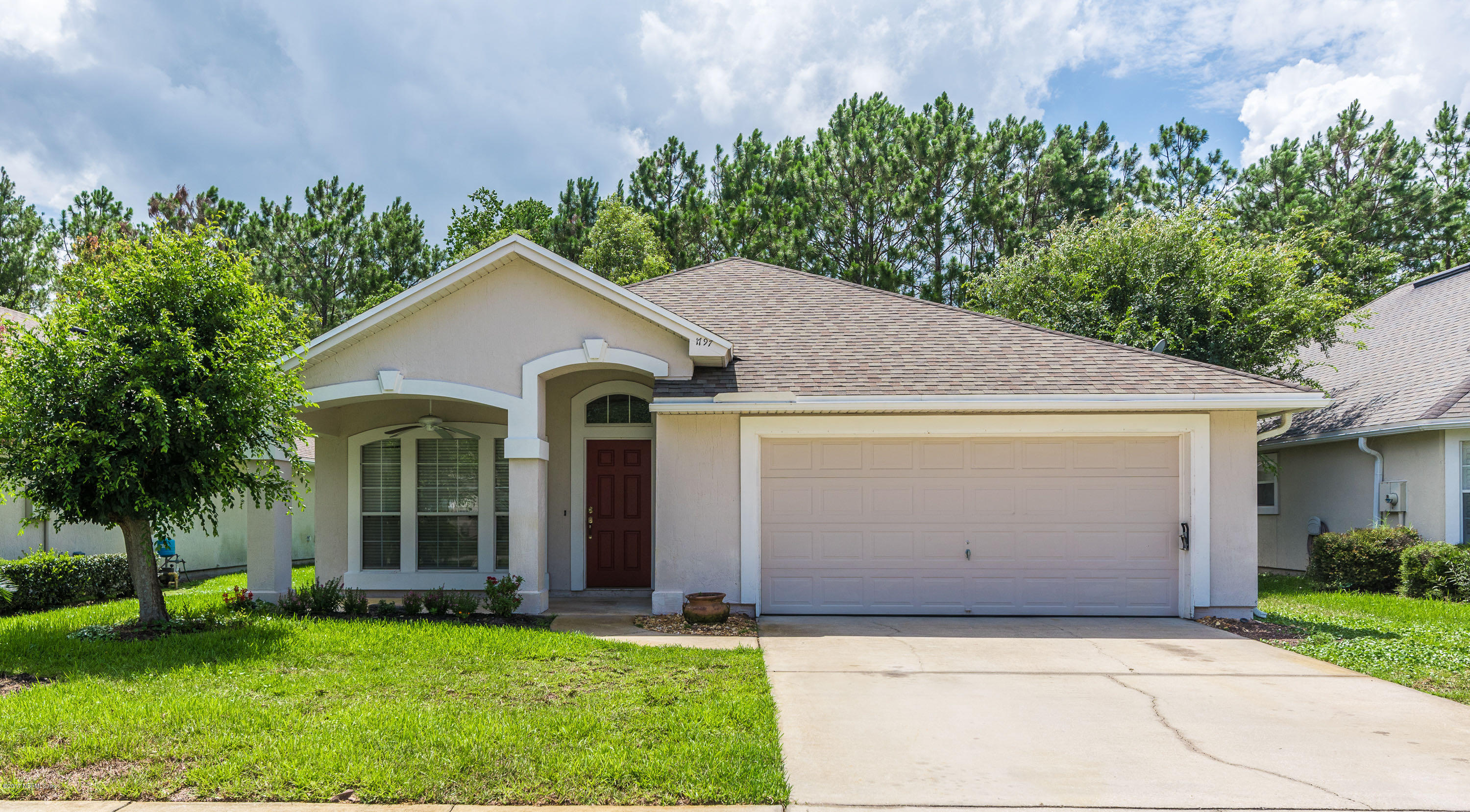 1797 Keswick Road St. Augustine, FL 32084 - Photo 1 of 31 a front view of a house with a yard and garage