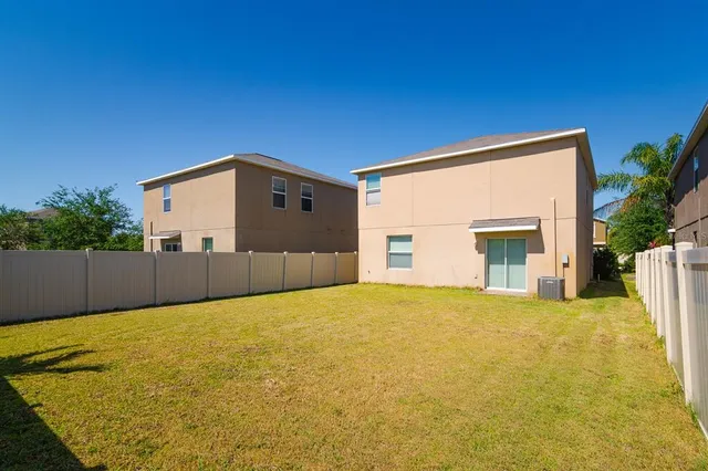 a view of a house with a backyard