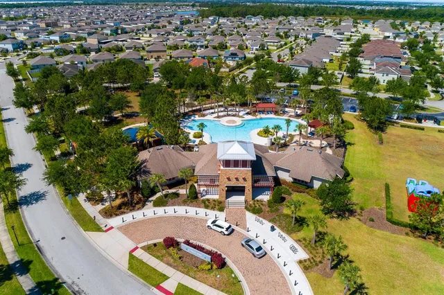 an aerial view of a house with a swimming pool yard and outdoor seating