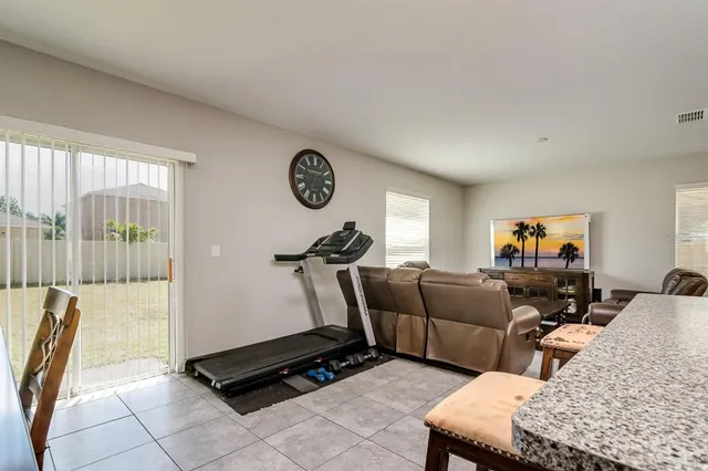 a living room with furniture a window and a flat screen tv