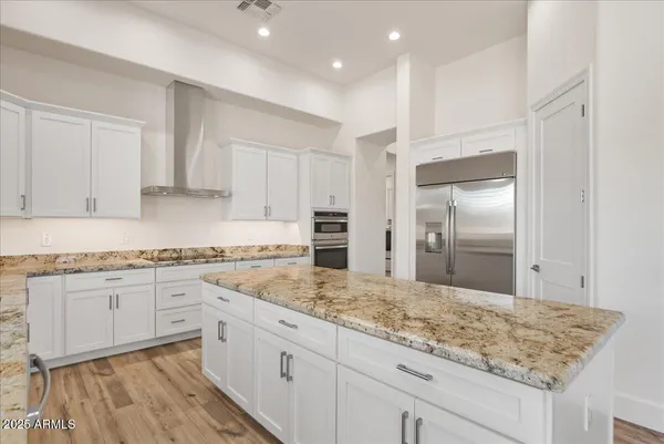 a large kitchen with granite countertop a sink and stainless steel appliances