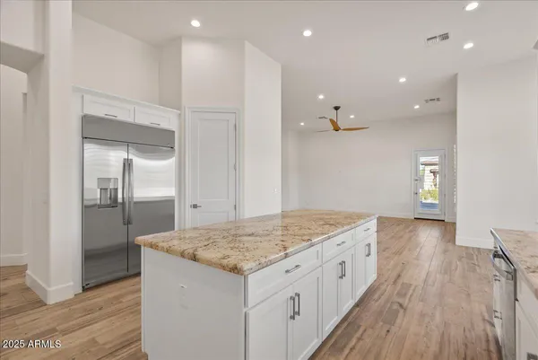 a kitchen with a sink and chandelier