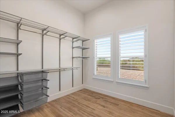 a view of walk in closet with empty racks