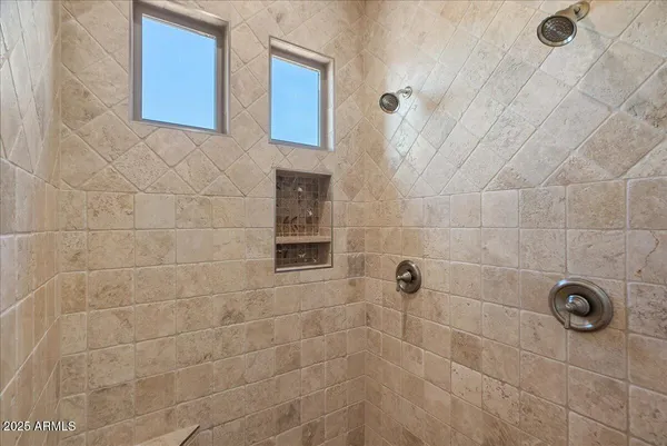 a spacious bathroom with a double vanity sink a mirror and a bathtub