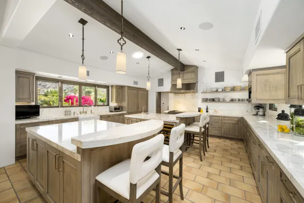 a kitchen with stainless steel appliances granite countertop a sink and a stove