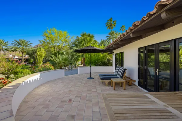 a view of a house with a yard patio and fire pit