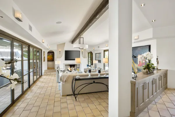 a large kitchen with kitchen island a large counter top space and stainless steel appliances