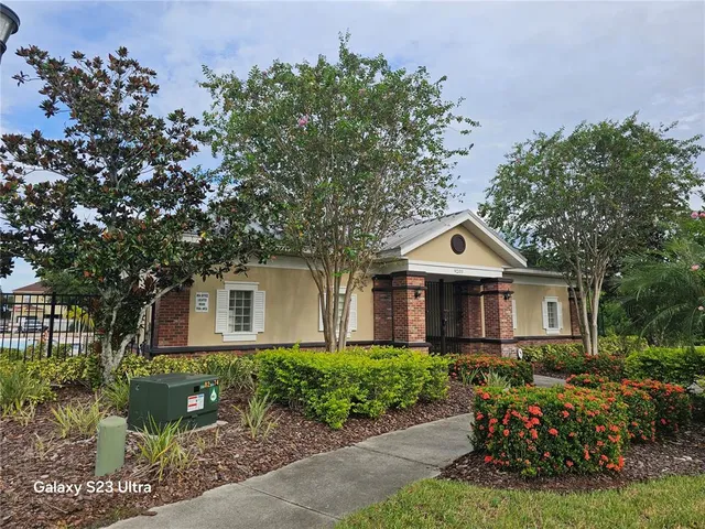 a front view of a house with a yard and trees