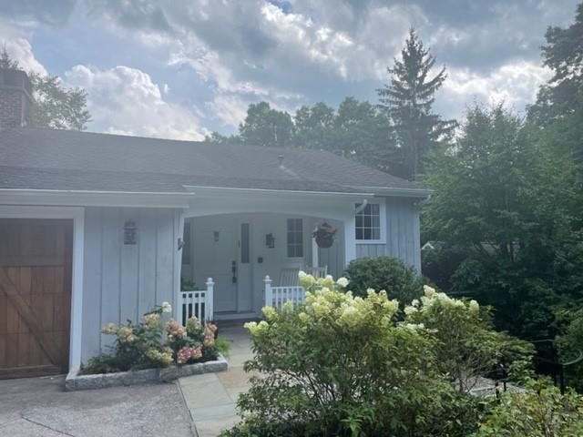 94 Honey Hollow Road Pound Ridge, NY 10576 - Photo 1 of 1 a front view of a house with garden