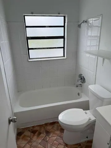 a view of a utility room with cabinet