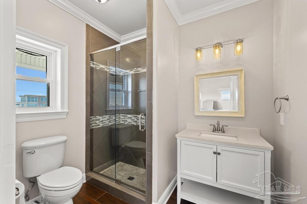 321 Gulfview Lane Perdido Key, FL 32507 - Photo 34 of 57 a bathroom with a toilet a sink a glass door a shower a mirror and vanity