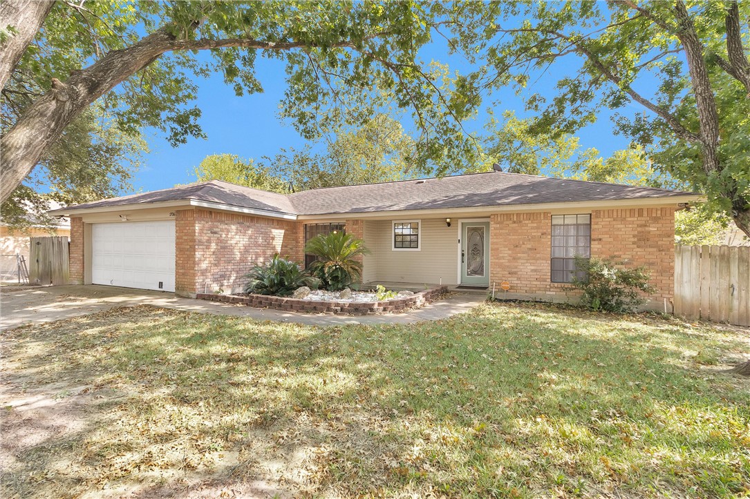1706 Shawnee Street Navasota, TX 77868 - Photo 1 of 25 a view of a house with a backyard and a tree