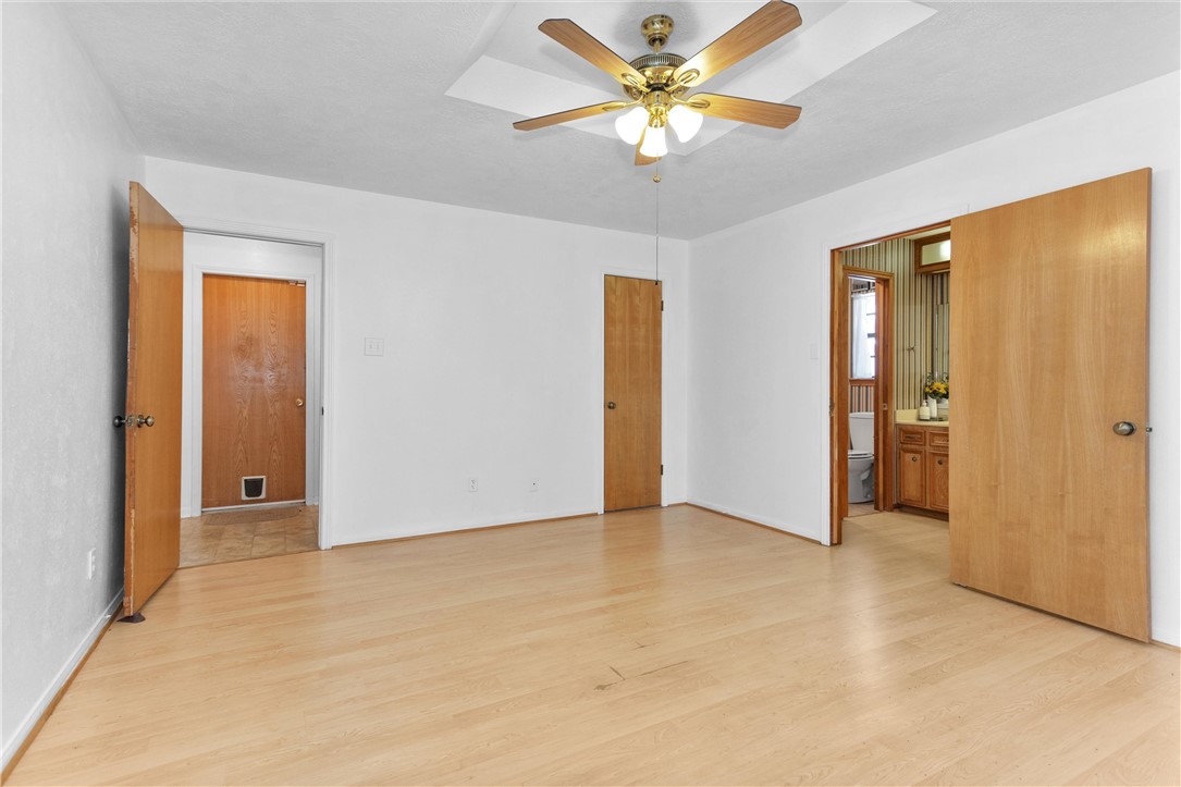 1706 Shawnee Street Navasota, TX 77868 - Photo 13 of 25 an empty room with closet and a chandelier fan