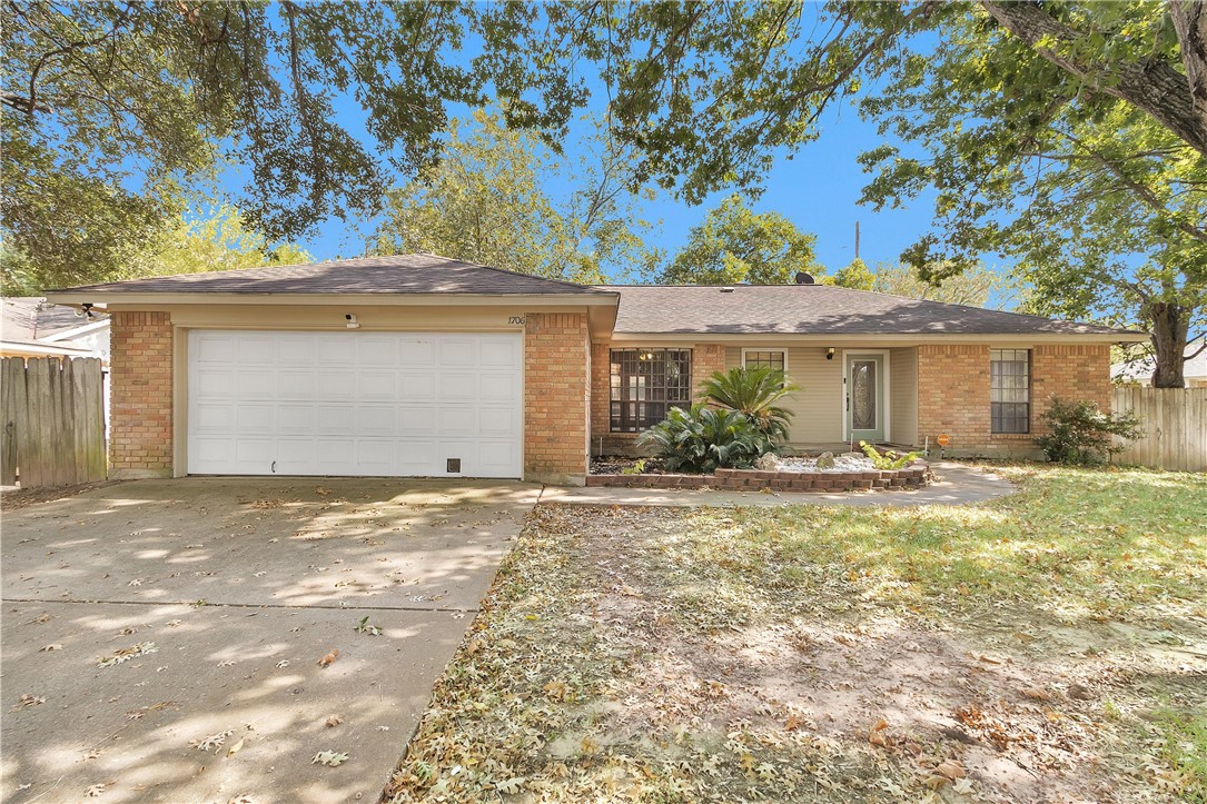 1706 Shawnee Street Navasota, TX 77868 - Photo 3 of 25 a front view of a house with a yard and garage