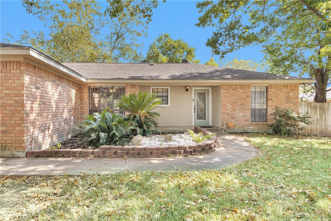 1706 Shawnee Street Navasota, TX 77868 - Photo 4 of 25 a front view of a house with garden