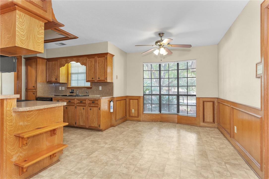 1706 Shawnee Street Navasota, TX 77868 - Photo 10 of 25 a large kitchen with kitchen island granite countertop a stove a sink a window and dining table