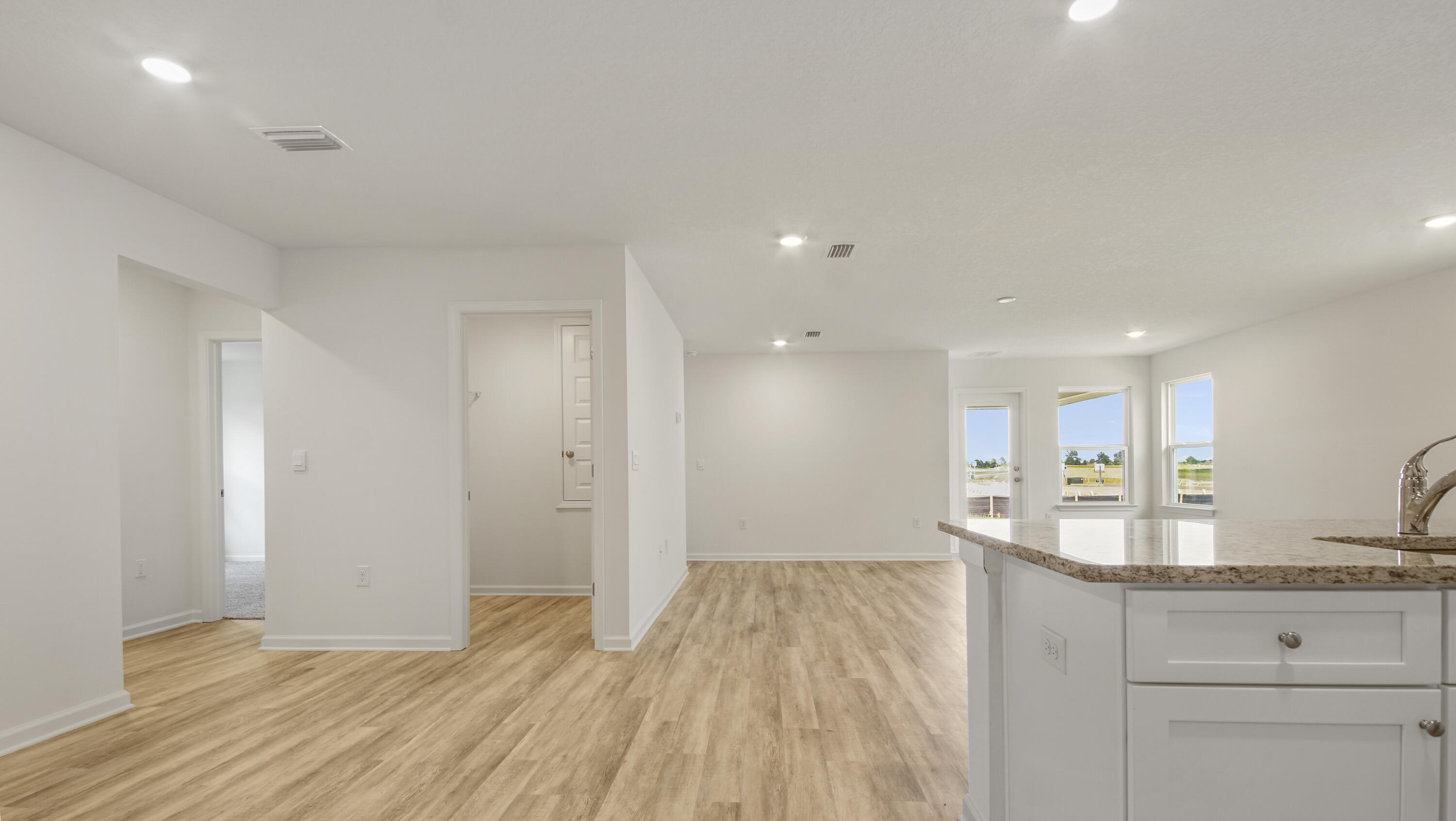 234 Gray Owl Drive Freeport, FL 32439 - Photo 3 of 37 a view of a kitchen with center island and wooden floor