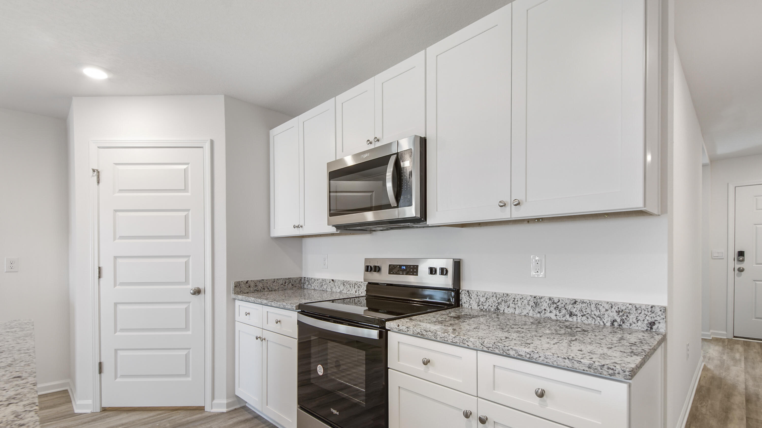 234 Gray Owl Drive Freeport, FL 32439 - Photo 6 of 37 a kitchen with white cabinets and appliances