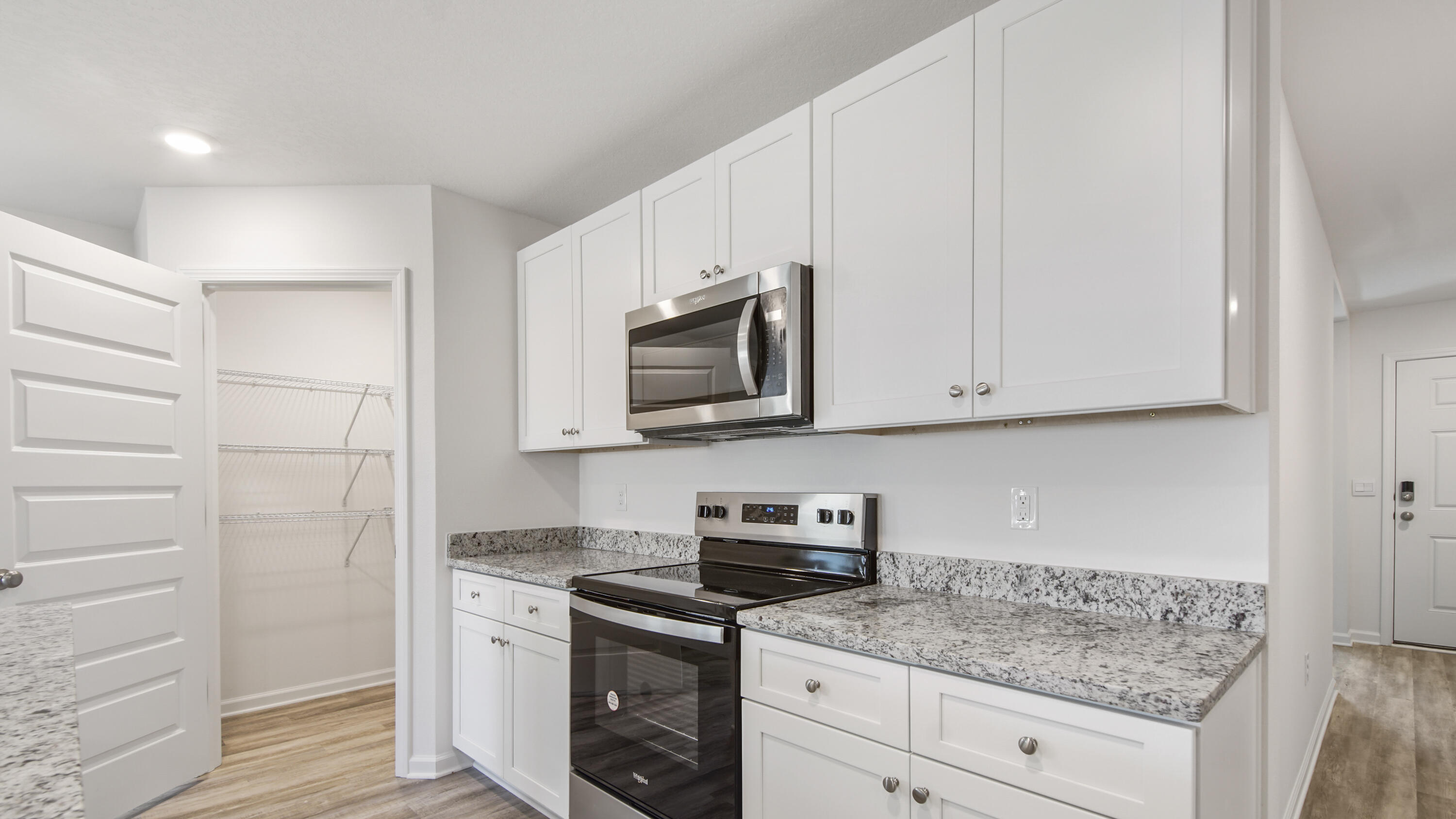 234 Gray Owl Drive Freeport, FL 32439 - Photo 7 of 37 a kitchen with granite countertop white cabinets and stainless steel appliances