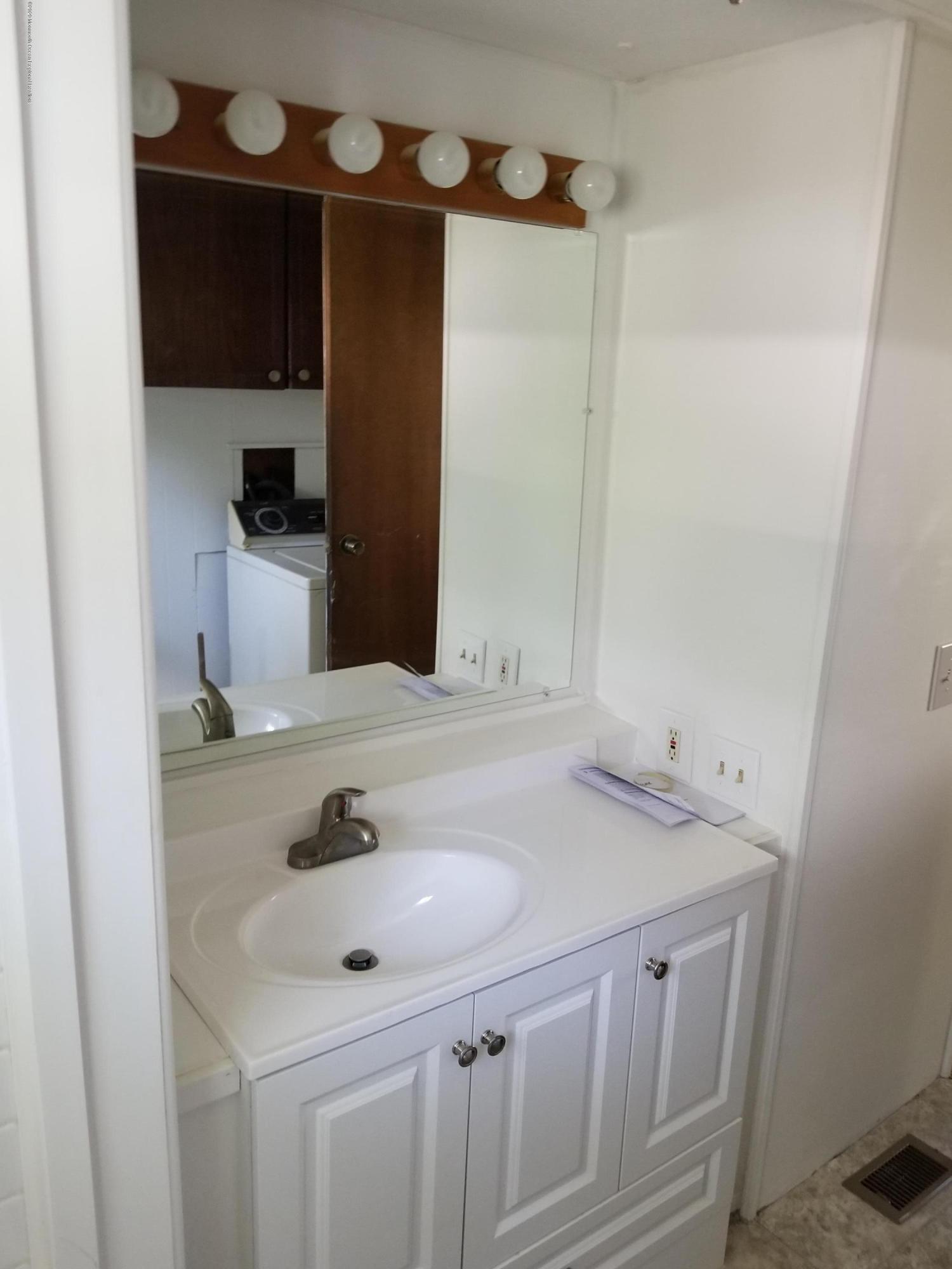 5 Antonia Drive Jackson, NJ 08527 - Photo 7 of 8 a bathroom with a sink and a mirror