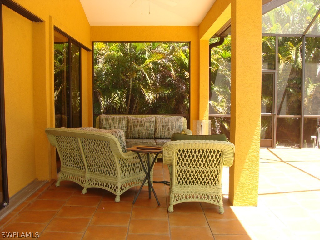 13710 Robert Road Bokeelia, FL 33922 - Photo 15 of 24 a view of a chair and table in the back yard of the house