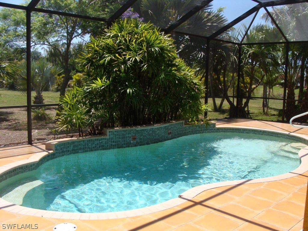 13710 Robert Road Bokeelia, FL 33922 - Photo 19 of 24 a view of a backyard with large trees