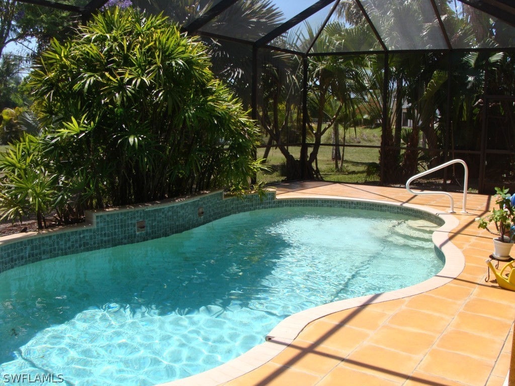 13710 Robert Road Bokeelia, FL 33922 - Photo 20 of 24 a backyard of a house with barbeque oven