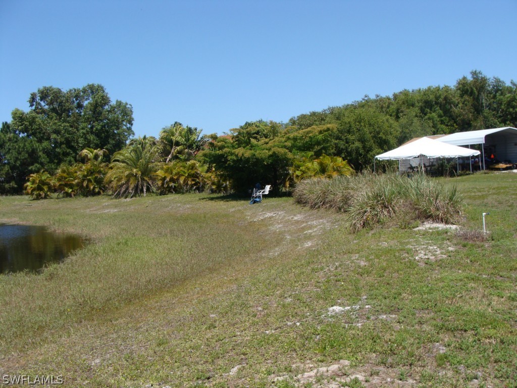 13710 Robert Road Bokeelia, FL 33922 - Photo 23 of 24 a view of a field with an trees