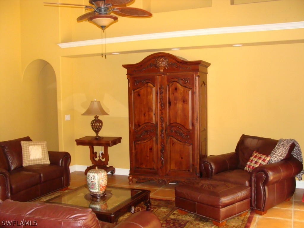 13710 Robert Road Bokeelia, FL 33922 - Photo 3 of 24 a living room with furniture and a mirror