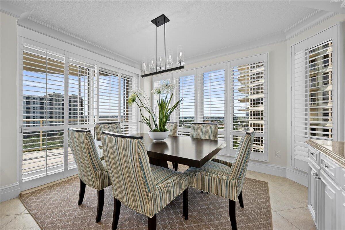 3920 North Ocean Drive, Unit 11B Singer Island, FL 33404 - Photo 15 of 58 a view of a dining room with furniture window and wooden floor
