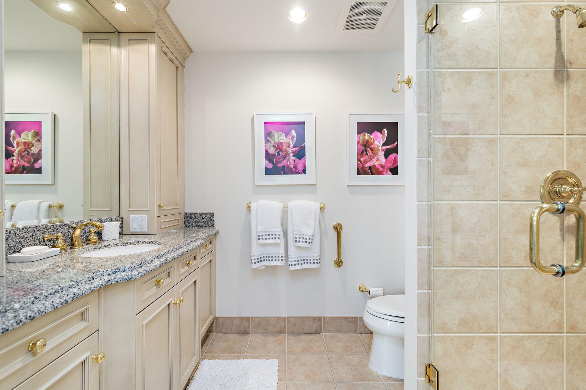 3920 North Ocean Drive, Unit 11B Singer Island, FL 33404 - Photo 29 of 58 a bathroom with a granite countertop sink mirror vanity and toilet