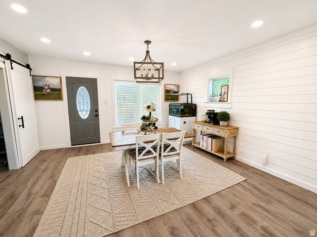 303 North Main Street Grace, ID 83241 - Photo 8 of 22 Spacious room featuring wood-finish flooring and a white shiplap accent wall
