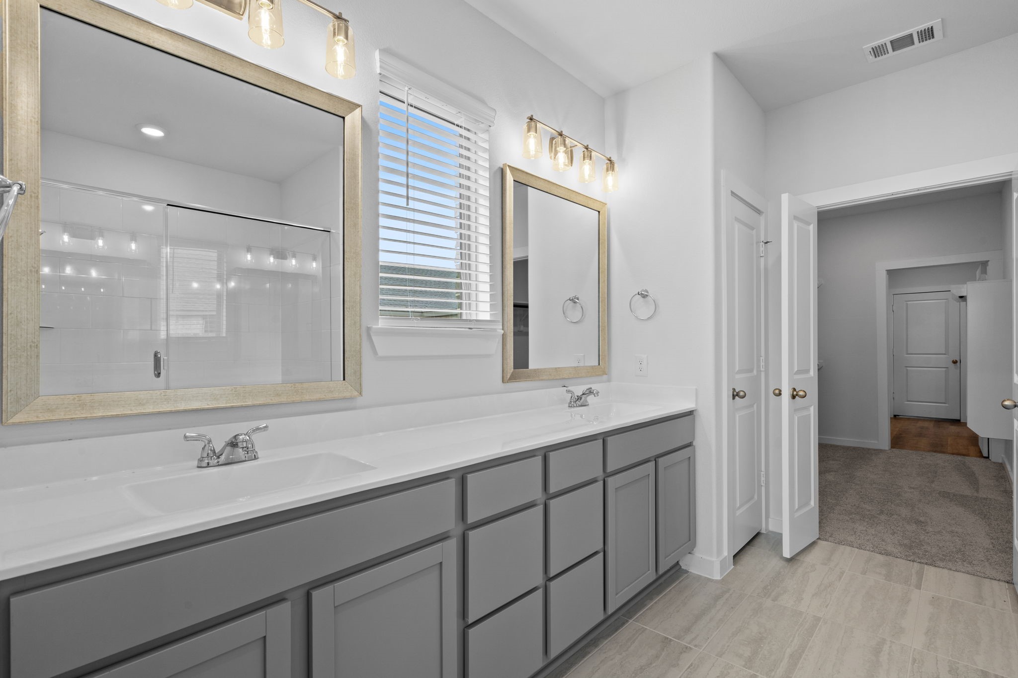 332 Gambels Quail Road Waller, TX 77484 - Photo 11 of 27 a bathroom with a double vanity sink and mirror