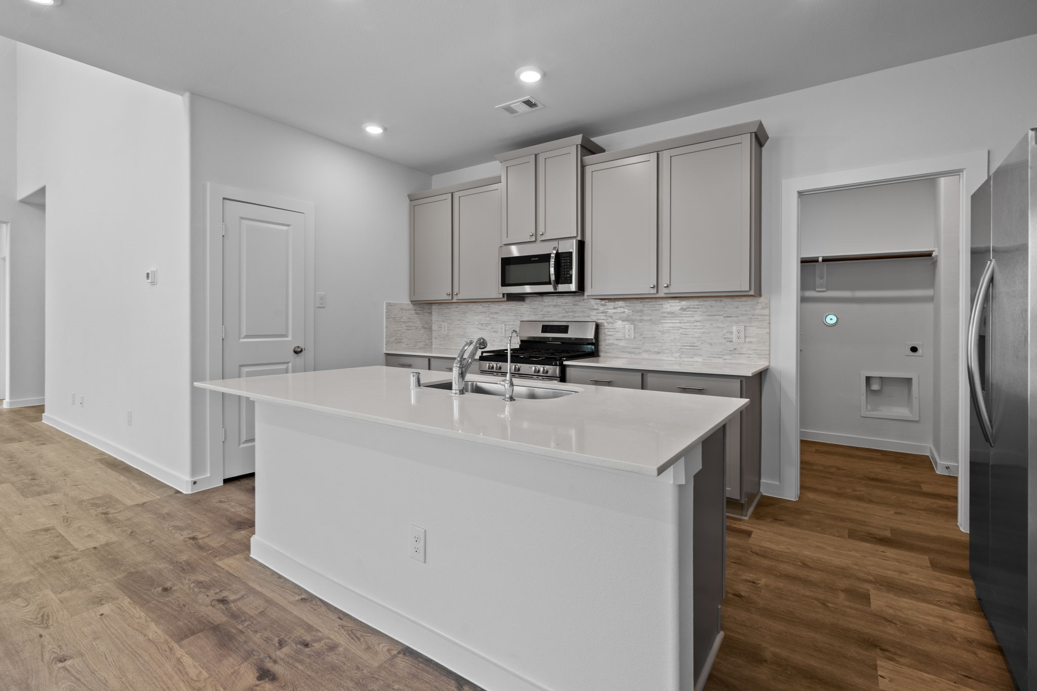 332 Gambels Quail Road Waller, TX 77484 - Photo 6 of 27 a kitchen with stainless steel appliances granite countertop a sink stove and refrigerator
