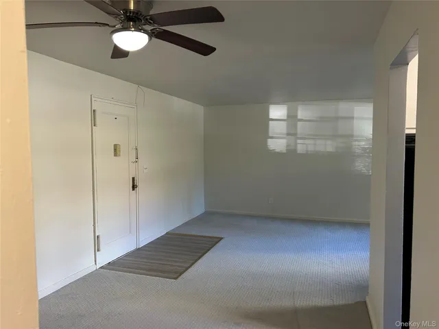 a kitchen with white cabinets and black appliances