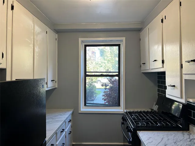 a kitchen with granite countertop a stove and a sink