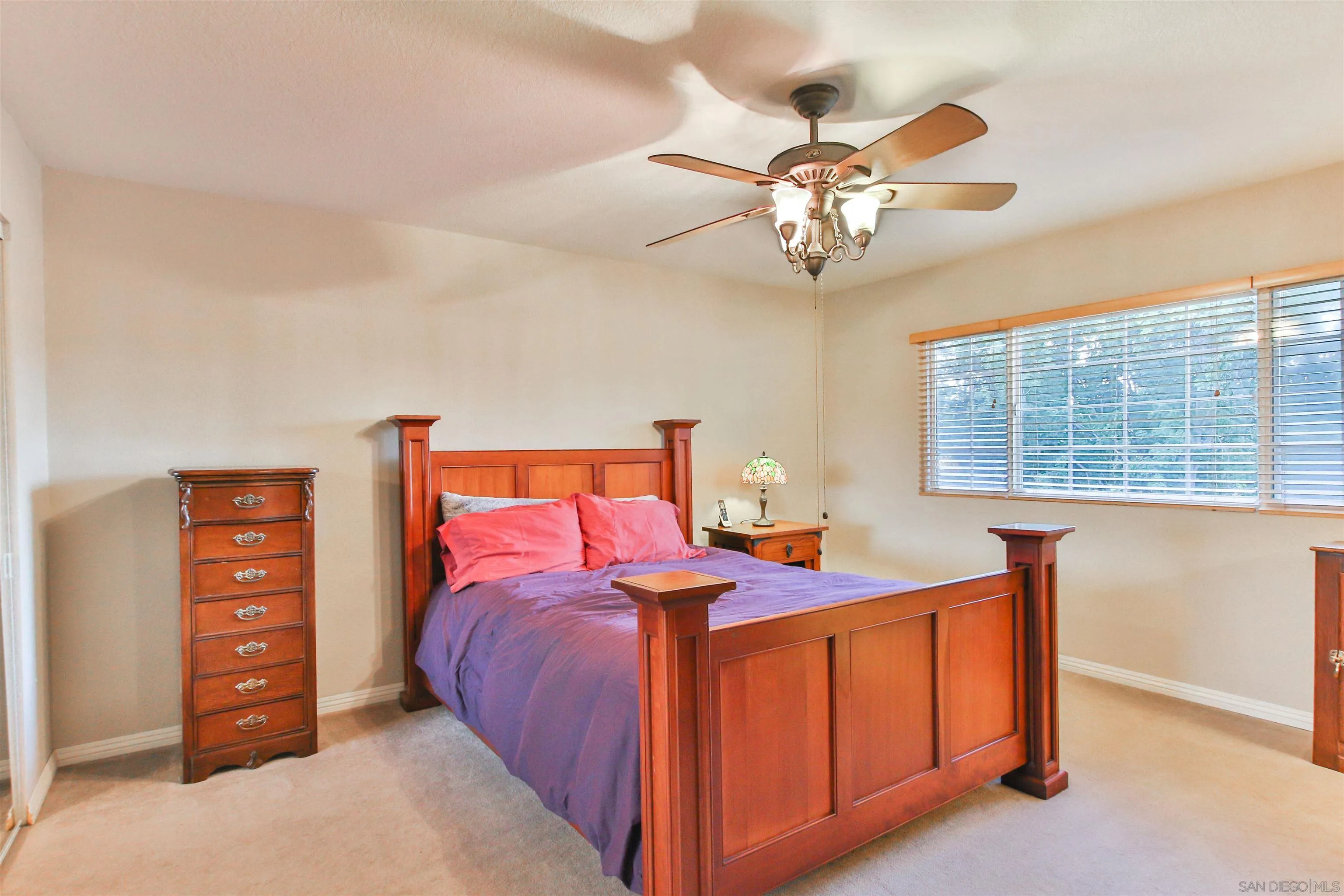 648 Norwynn Lane Fallbrook, CA 92028 - Photo 11 of 17 a bedroom with a bed and a chandelier
