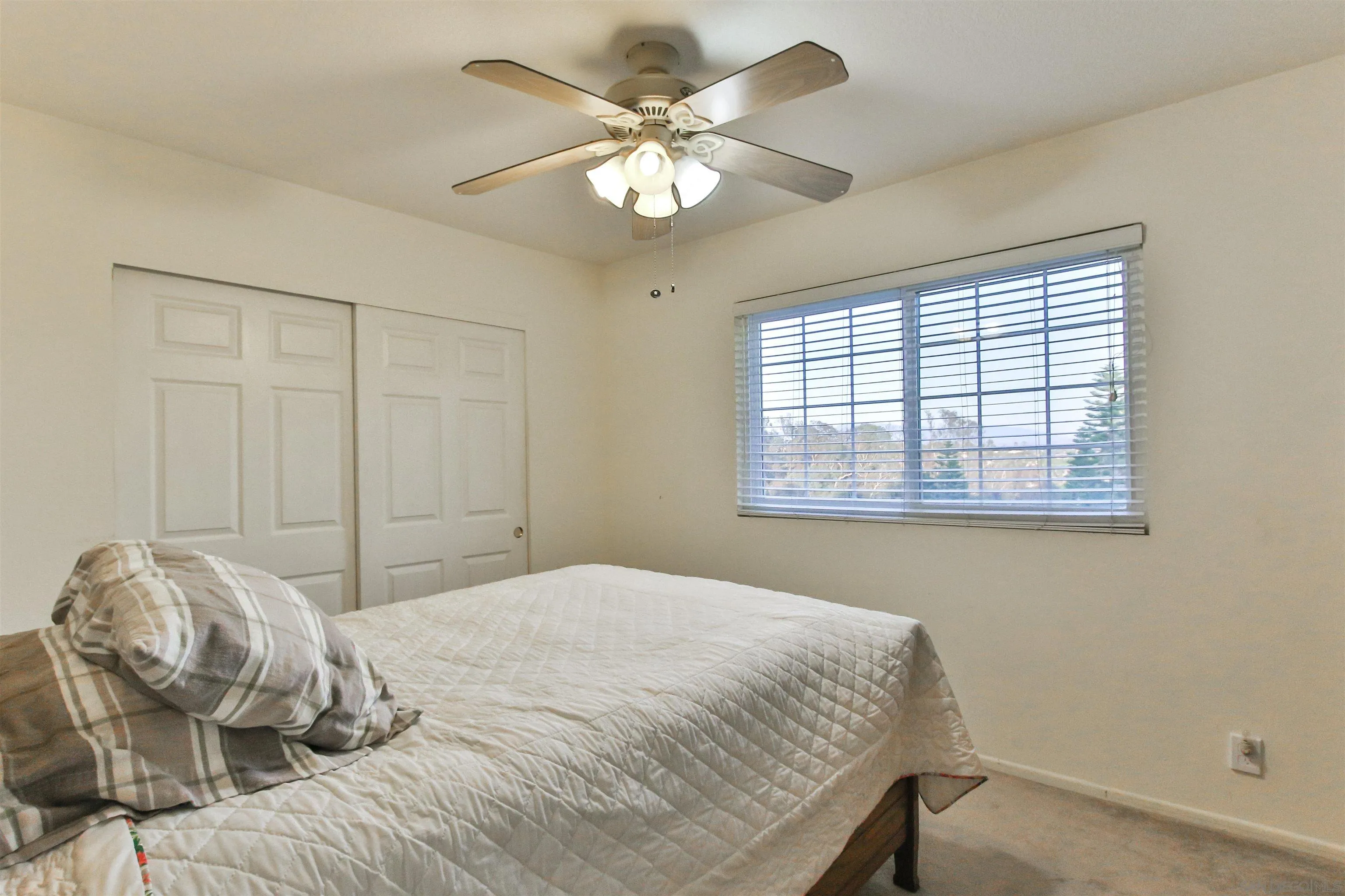 648 Norwynn Lane Fallbrook, CA 92028 - Photo 13 of 17 a bedroom with a bed and a chandelier