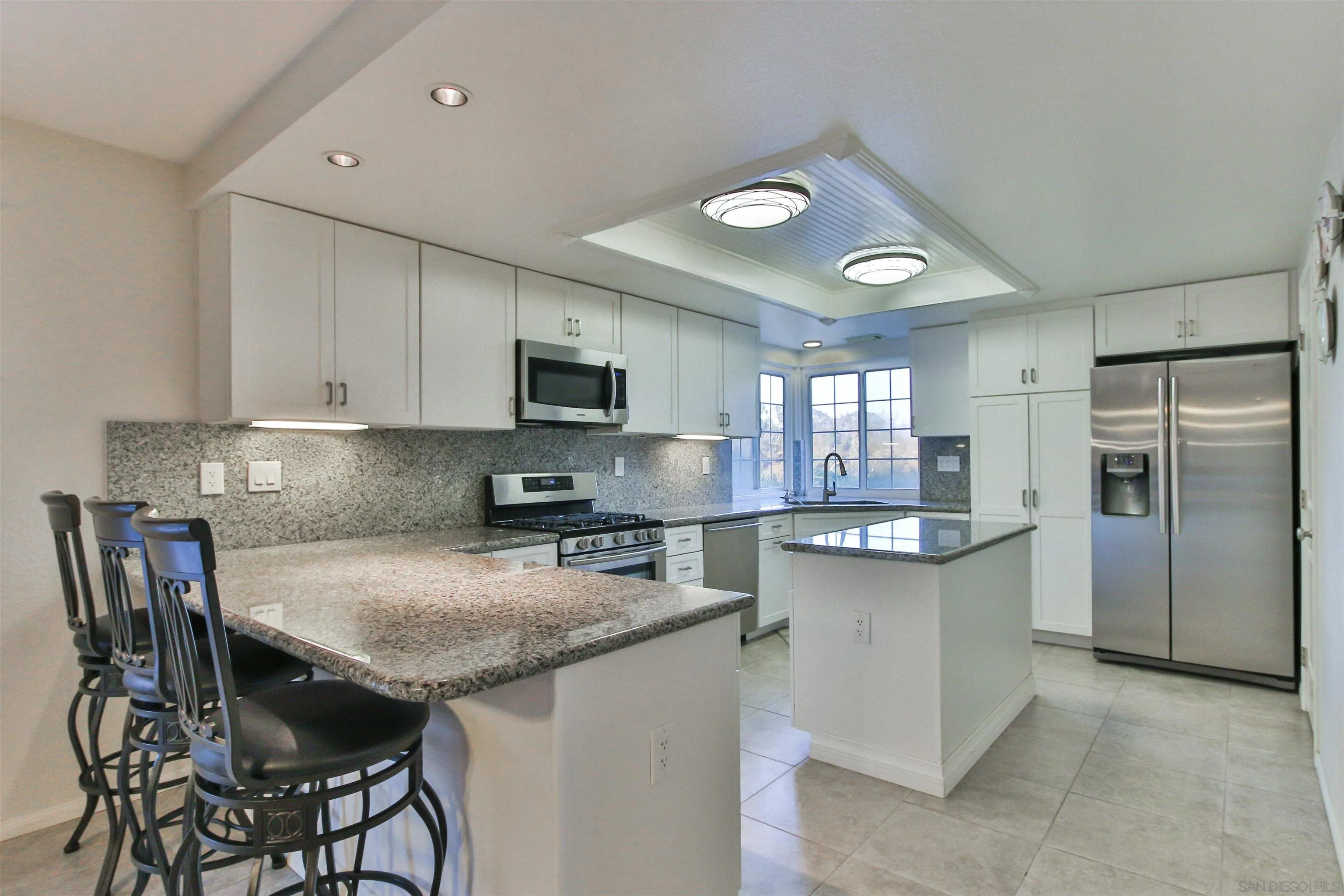 648 Norwynn Lane Fallbrook, CA 92028 - Photo 6 of 17 a kitchen with kitchen island granite countertop a sink and appliances