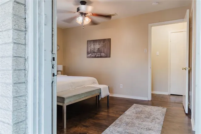 a bedroom with a bed and a table with potted plant